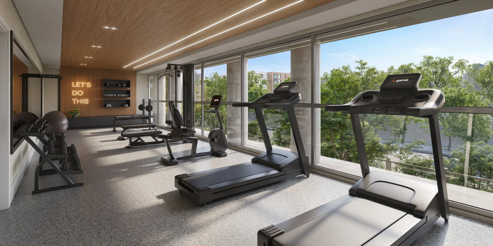Espaço fitness do Pátio Múcio com esteiras, racks de peso e painel de madeira